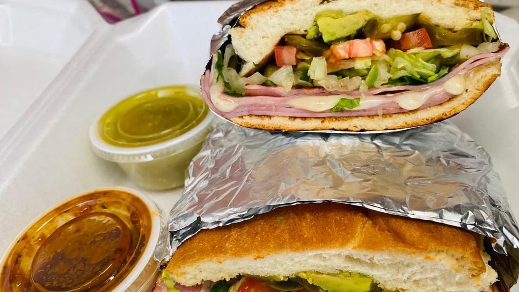 Tortas · Mexican sandwich: fluffy bun spread with butter and topped with meat, lettuce, tomato, onions, cilantro, pickled jalapeños mayonnaise and avocado.