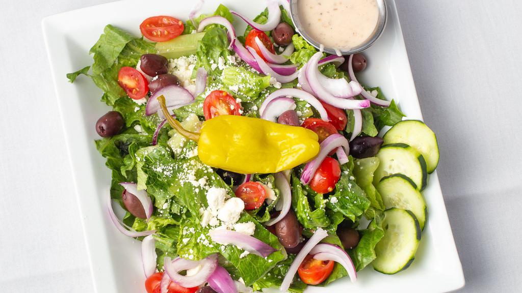 Greek Salad · Romaine lettuce, cucumbers, tomatoes, feta cheese, kalamata olives, red onion, pepperoncini. Served with side of balsamic vinaigrette.