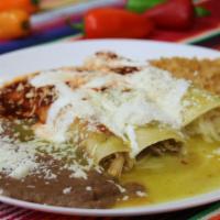 Mexican Enchiladas · Served with rice beans sour cream and cheese.