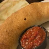 Spinach, Chicken And Artichoke Heart Calzone · A savory white sauce calzone with fresh spinach and artichoke hearts.