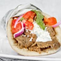 Gyro Sandwich · Sizzling gyro slices, lettuce, tomatoes, red onions, feta cheese and tzatziki sauce wrapped ...