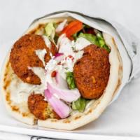 Falafel Sandwich · Falafel and hummus with lettuce, tomatoes, red onions, feta cheese and tahini sauce wrapped ...