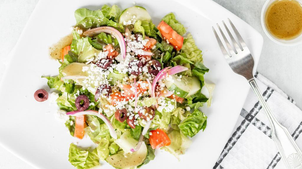 Greek Salad · Romaine lettuce, feta cheese, green peppers, red onions, Kalamata olives and tomatoes served with Greek dressing.