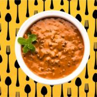 Dal Makhani · Black lentils and red kidney beans slow-cooked with herbs, butter and cream. Served with a p...