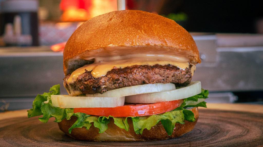 Classic Burly Burger · Classic American burger with lettuce, tomato, onions, and Burly sauce (like fry sauce) on a brioche bun.