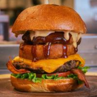 The Duke · The Western Burly burger topped with cheddar cheese, onion rings, bacon, fry sauce, and BBQ ...