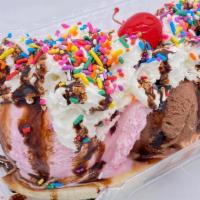 Banana Split · Banana topped with ice cream (two scoops), whip cream, sprinkles, a cherry, and chocolate sy...