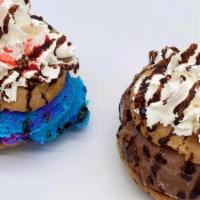Ice Cream Cookie Sandwich · Two chocolate chip cookies with ice cream, whipped cream, chocolate syrup, and sprinkles.