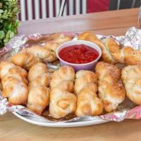 Garlic Parmesan Breadsticks · Fresh baked bread twists basted with garlic butter and sprinkled with parmesan cheese. Serve...