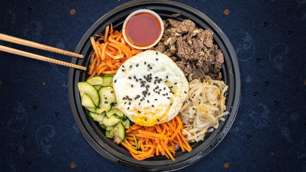 Beloved Bulgogi Bibimbap · Fresh carrots, zucchini, bean sprouts, and radish with our famous beef bulgogi piled on fresh white rice, topped with a special spicy gochujang sauce and a fresh sunnyside-up egg. Yum!