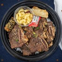 Bodacious Beef Rib Bowl  · Kalbi (beef rib) marinated daily in a house made sauce and grilled to perfection. Served wit...