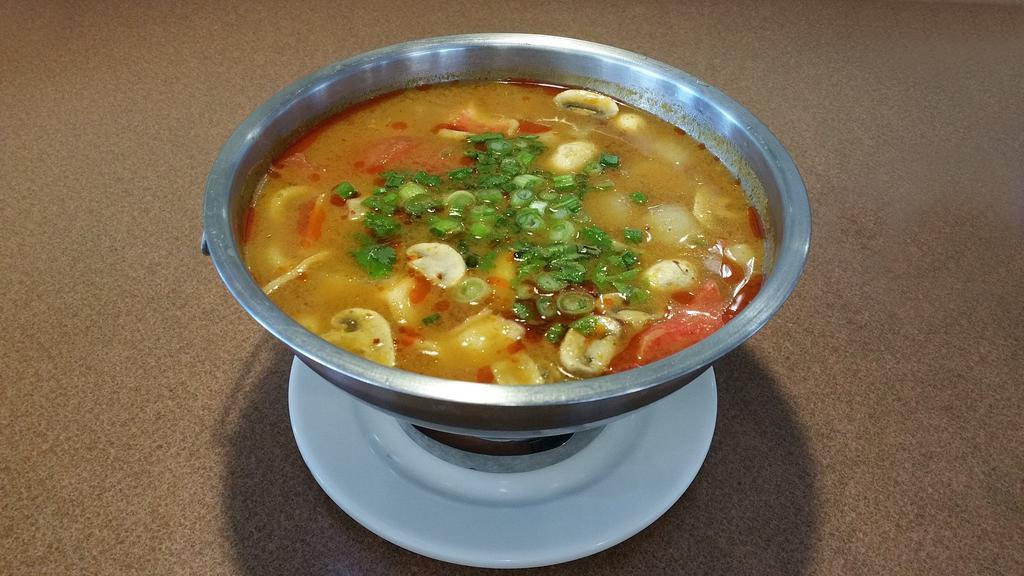 Tom Yum (Large) · Hot and sour clear soup with a touch of fresh lime juice, lemongrass, kaffir lime leaves, tomatoes, onions, mushroom, topped with green onions, cilantro.