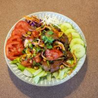 Beef Salad (Yum Nuea) · Sliced beef tossed with chili, cucumber, tomatoes, red onions, cilantro, rice powder, flavor...