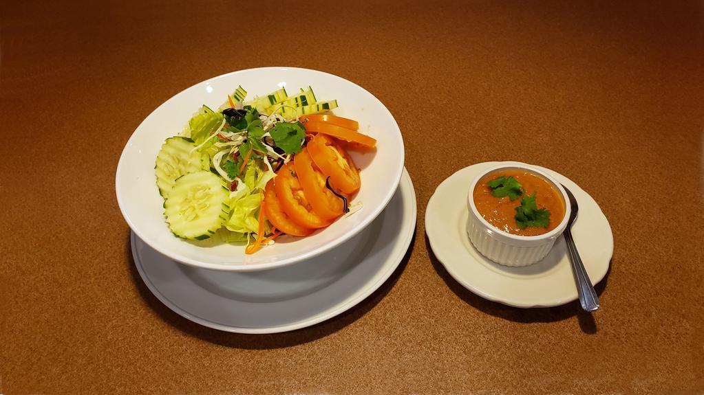 Garden Salad · Lettuce, sliced cucumber, tomatoes, carrot, shredded cabbage in house peanut dressing.