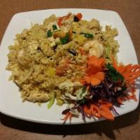Pineapple Fried Rice · Stir fried steamed jasmine rice with egg, chicken, shrimp, onions, tomatoes, pineapple, gree...