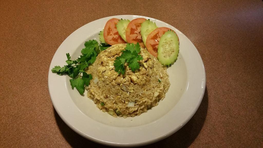 Crab Fried Rice · Stir fried steamed jasmine rice with crab, egg, onions, peas and carrots.