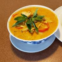 Red Curry (Kang Dang) · Red curry paste, coconut milk, bamboo shoot, bell pepper, and basil leaves.