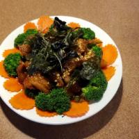 Crispy Basil Chicken · Crispy chicken with sweet and spicy sauce topped with crispy basil and broccoli.