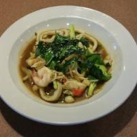 Spicy Seafood · Stir fried with bamboo bell pepper, onion broccoli with elili sauce. Topped with crispy basil.