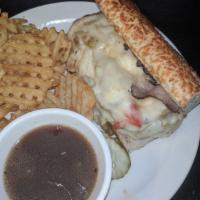Cheesy Beef Sandwich · Thin-sliced roast beef, slow cooked in rich garlic au jus. Topped with sweet peppers and mel...