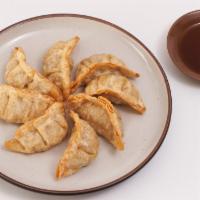 Gyoza (Pot Stickers) (8) · Fried beef and vegetable dumplings served with our savory soy-ginger sauce