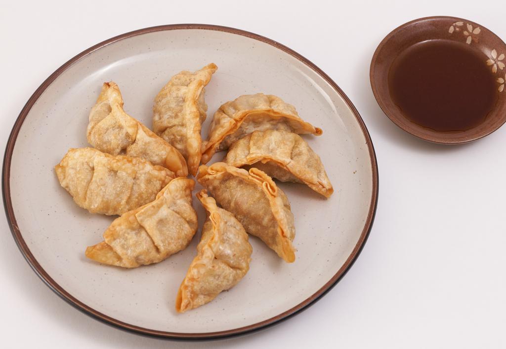 Gyoza (Pot Stickers) (8) · Fried beef and vegetable dumplings served with our savory soy-ginger sauce