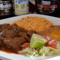 Chile Colorado · Beef simmered until until very tender in a red sauce, green peppers, onions, and spices. Ser...