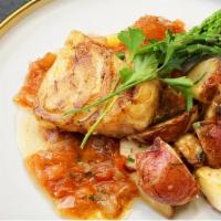 Sea Bass · Sustainably harvested sea bass with red potatoes, asparagus and a roasted tomato tarragon vi...