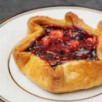 Triple Berry Crostata · Blueberries, raspberries and blackberries mixed with apples in a rustic flakey tart shell.