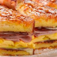 Monte Cristo Sandwich · Crunchy French Toast Stuffed with Bacon, Grilled Ham, Scrambled Eggs and Melted Swiss Cheese...