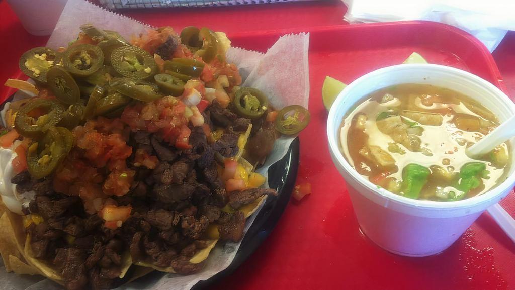 Supreme Nachos · Tortilla chips topped with melted cheese, refried beans, sour cream, guacamole, pico de gallo, jalapeños, and choice of meat.