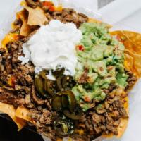 Supreme Nachos · Tortilla chips topped with melted cheese, refried beans, sour cream, guacamole, pico de gall...