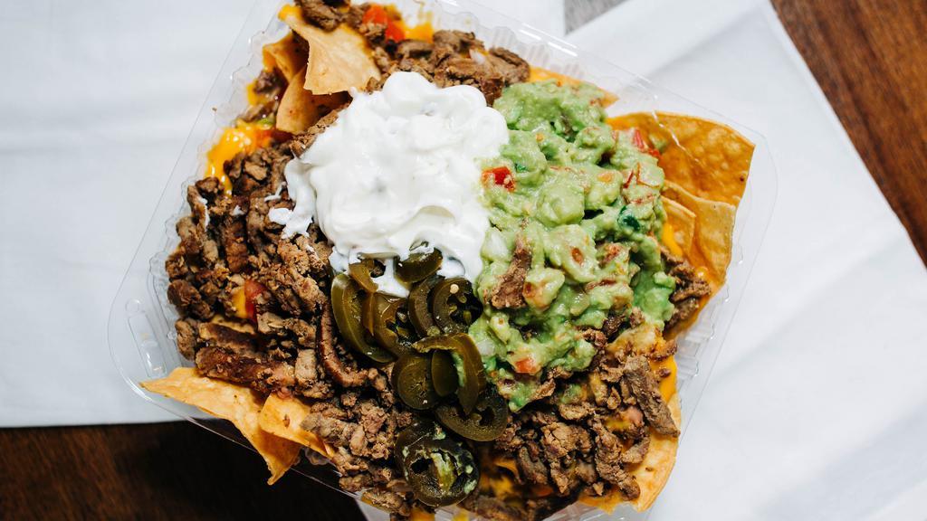 Supreme Nachos · Tortilla chips topped with melted cheese, refried beans, sour cream, guacamole, pico de gallo, jalapeños, and choice of meat.