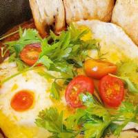 Harissa Shakshuka · roasted red pepper sauce, sunny side up eggs, marinated olives & feta, sourdough