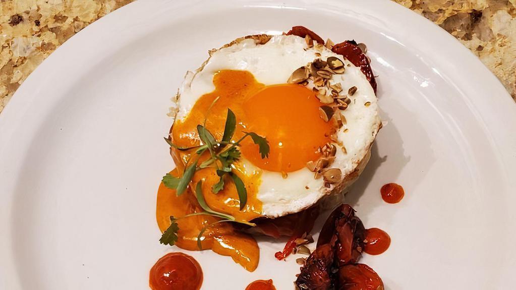 Iberico Sandwich · Toasted sourdough, house cured Iberico lomo, p'tit basque, manchego, roasted tomatoes, pimiento, fried egg, and spiced butter sauce