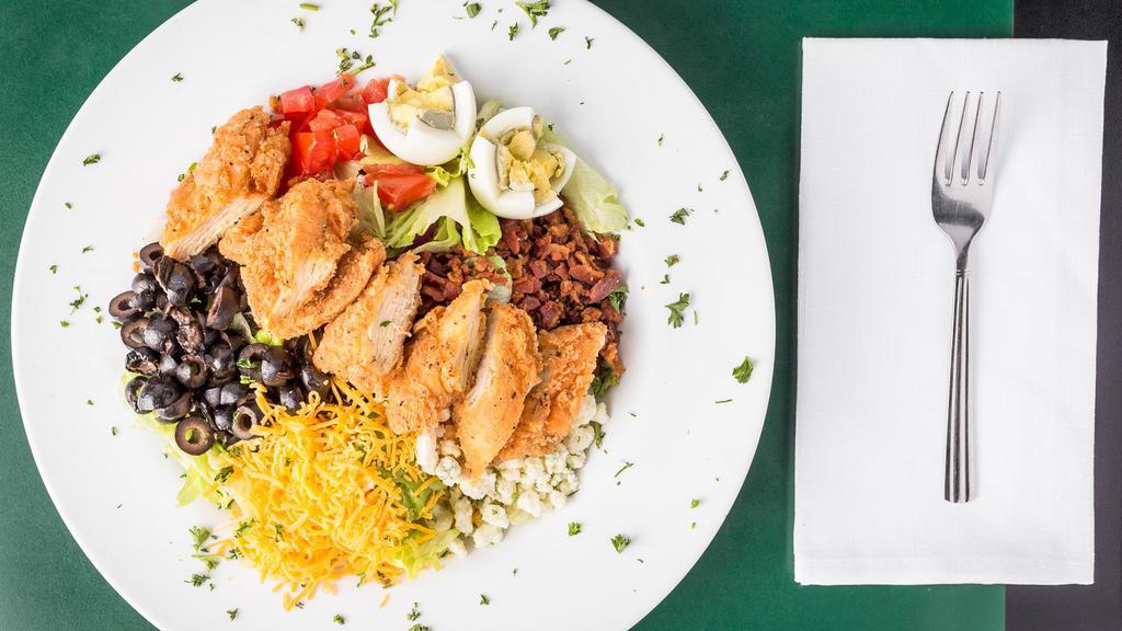 Cobb Salad · Fresh greens topped with grilled chicken, black olives, bacon, blue cheese crumbles, egg and tomatoes. Served with your choice of dressing.