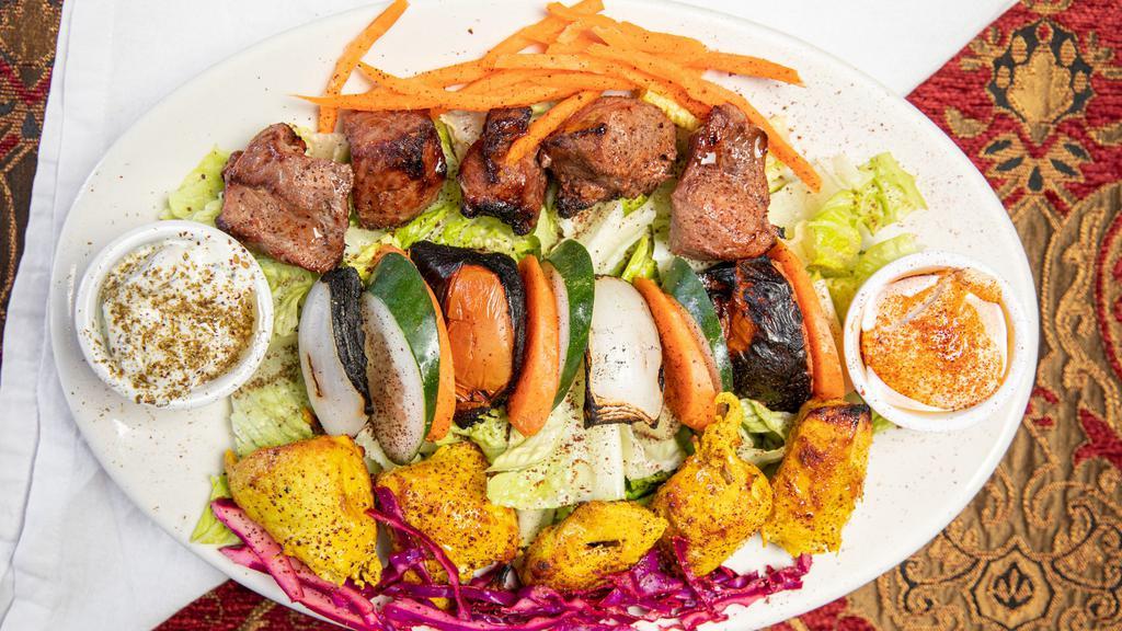 Mixed Grill · Made without gluten. A meat plate of chicken kabob and lamb kabob served with grilled onions and tomato with your choice of bread or veggies.
