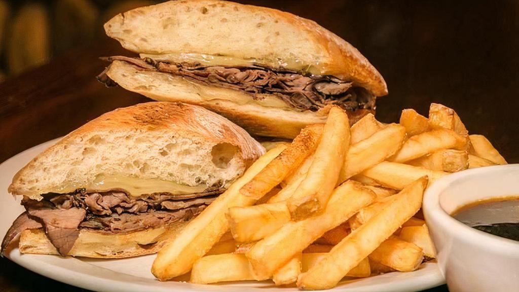 Pardon Our French Dip · Roast beef simmered in au jus then piled high on grilled garlic buttered baguette with melted swiss cheese. Served with a side of au jus.