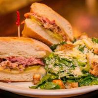 Cuban O · Slow roasted pulled pork, ham on toasted baguette topped with Swiss cheese, pickles, and for...