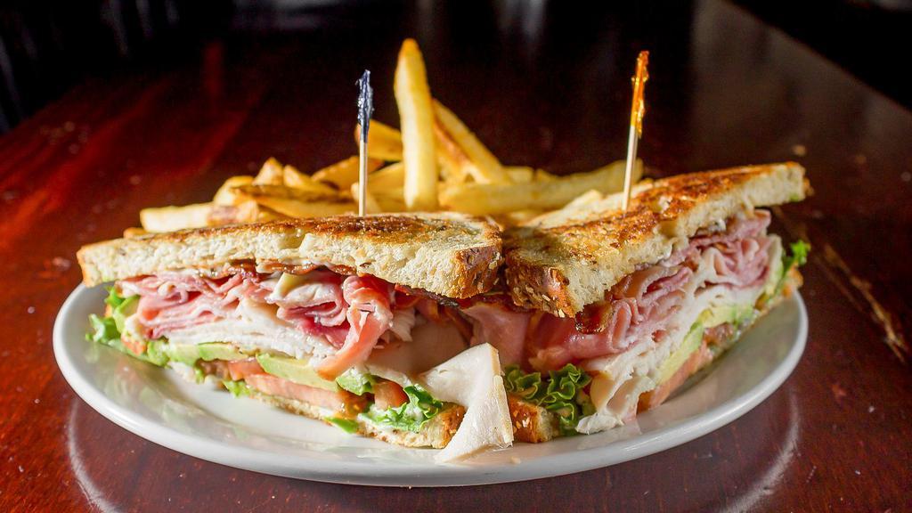 Ol Supper Club · Grilled nine grain bread layered with fresh roasted turkey, bacon, ham, lettuce, tomato, avocado, and mayonnaise.