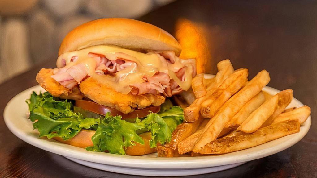 Ponderosa · Own luxury version of a chicken sandwich with breaded tenders, ham, and Swiss. Served with lettuce, tomato, pickles, and mayonnaise on a brioche bun.