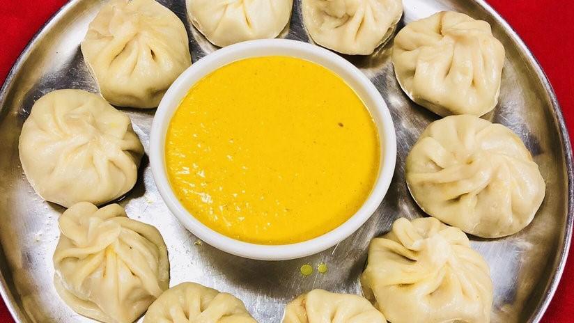 Chicken Momo · Steamed chicken dumpling mildly spiced with ginger, garlic, onion and spices.