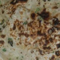 Garlic Naan · Veg. Tandoori baked flatbread topped with fresh garlic and cilantro.