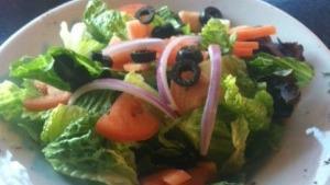 House Salad · Mixed greens with tomatoes, red onions, and black olives.