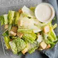 Side Caesar Salad · Crisp fresh romaine lettuce mixed with creamy caesar dressing topped with croutons and shave...