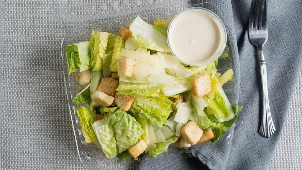 Side Caesar Salad · Crisp fresh romaine lettuce mixed with creamy caesar dressing topped with croutons and shaved parmesan cheese.