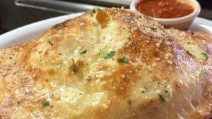 Cheese Calzone · Served with fresh marinara sauce. our freshly made dough filled with seasoned ricotta cheese...