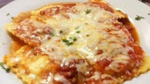 Cheese Ravioli · Cheese ravioli with marinara sauce and mozzarella cheese baked in our stone oven.