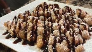 Cinnamons · Comes with powdered sugar and chocolate drizzle.