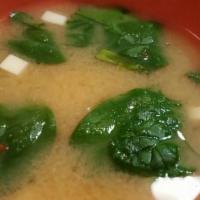 Spicy Miso Soup · miso soup with spicy tobanjan sauce, tofu, baby spinach, and scallions.